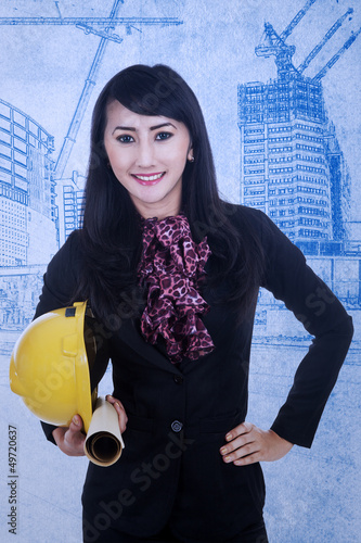 Photo: Close-up architect holding helmet Close-up architect holding helmet