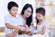 Photo: Happy teacher and preschooler paint easter eggs Happy teacher and preschooler paint easter eggs