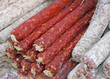 bunch of Salamis and spicy sausages with garlic for sale at the