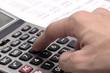 Male businessman using a calculator