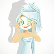 Girl in a natural cosmetic mask pack puts cucumbers on eyes