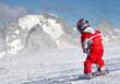 Little skier on a ski slope in The Alps.