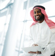 Photo: Black Arabic man working on laptop Black Arabic man working on laptop