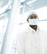 Working people with white uniforms in modern facility