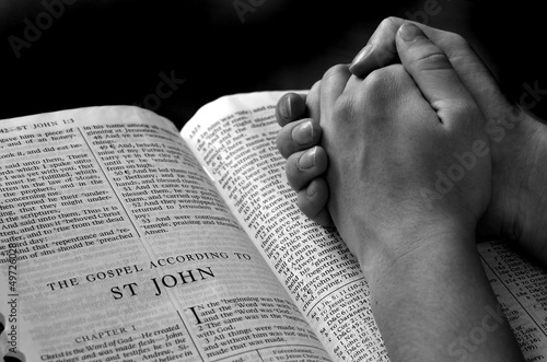 Photo: Hands Praying on Bible Hands Praying on Bible