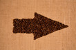 canvas print picture - Arrow from the coffee beans isolated on burlap