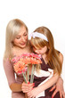 Happy mother and daughter sniffing flowers isolated