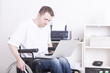 young man in wheelchair at work
