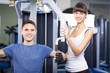 Photo: Cheerful young couple in a gym Cheerful young couple in a gym