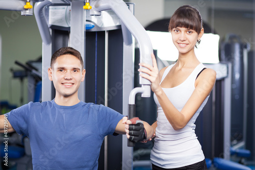 Photo: Cheerful young couple in a gym Cheerful young couple in a gym
