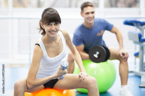Photo: Cheerful young couple in a gym Cheerful young couple in a gym