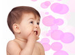 Adorable baby girl with the hands in her mouth
