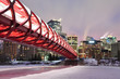 Calgary skyline and peace bridge at night.