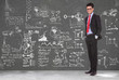 business man stands in front of blackboard