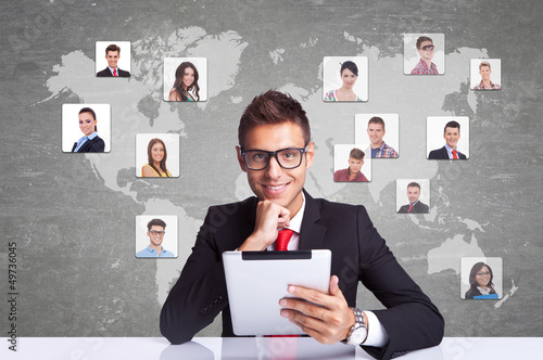 Photo: smiling business man with tablet pad networking smiling business man with tablet pad networking