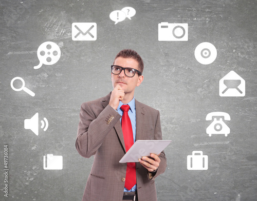 Photo: man with a tablet pad and icons on the background man with a tablet pad and icons on the background