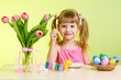 child painting Easter eggs