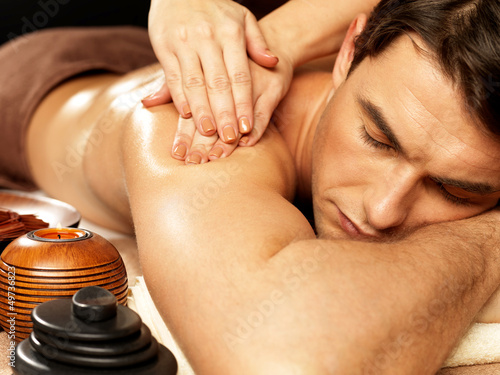Photo: Man having massage in the spa salon Man having massage in the spa salon
