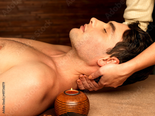 Photo: Man having neck massage in the spa salon Man having neck massage in the spa salon