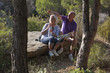 Foto: senior couple having a break while walking in the mountain senior couple having a break while walking in the mountain