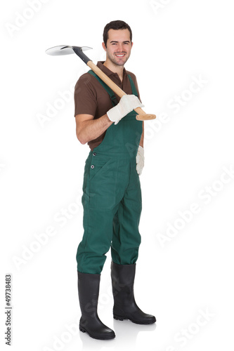 Photo: Happy young gardener in dungarees Happy young gardener in dungarees