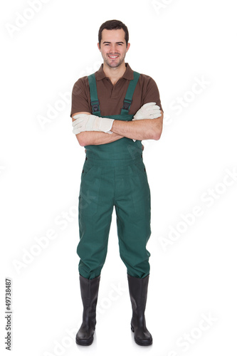 Photo: Happy young gardener in dungarees Happy young gardener in dungarees