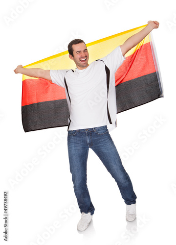 Photo: Portrait Of A Happy Man Holding An German Flag Portrait Of A Happy Man Holding An German Flag
