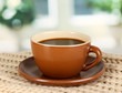 cup of coffee with scarf on table in room