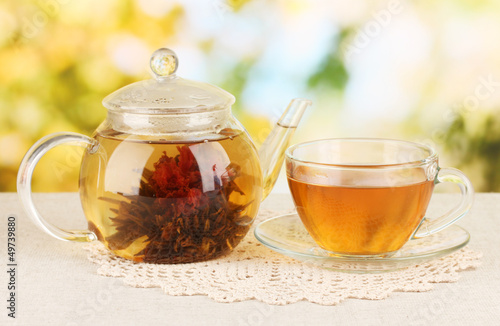Photo: Exotic green tea with flowers in glass teapot Exotic green tea with flowers in glass teapot