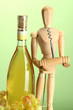 Mannequin with corkscrew and wine bottle, on green background