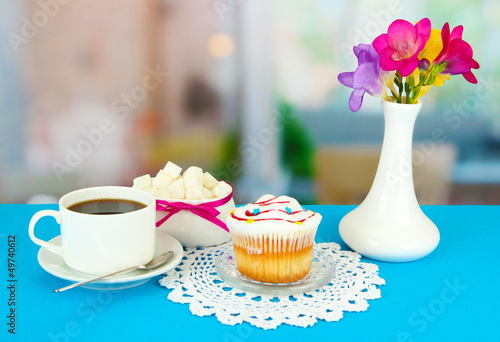 Photo: Cupcake on saucer with glass cover, on bright background Cupcake on saucer with glass cover, on bright background
