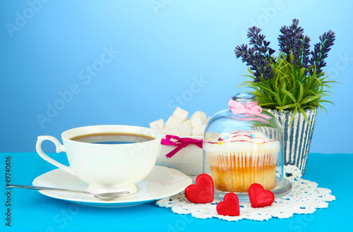 Photo: Cupcake on saucer with glass cover, on color background Cupcake on saucer with glass cover, on color background
