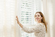 Smiling woman near window