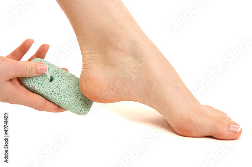 Photo: Woman having her foot scrubbed, isolated on white Woman having her foot scrubbed, isolated on white