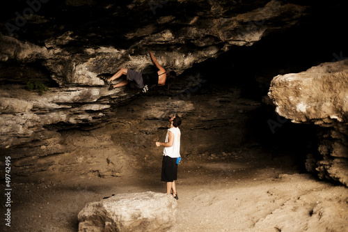 Photo: Young woman taking climbing lessons Young woman taking climbing lessons