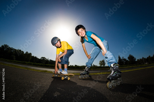 Photo: Active young people - rollerblading, skateboarding Active young people - rollerblading, skateboarding