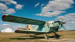 Time-lapse of clouds passing by over parked old passenger plane