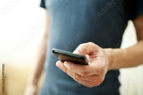 Photo: Close up of a man using mobile smart phone Close up of a man using mobile smart phone
