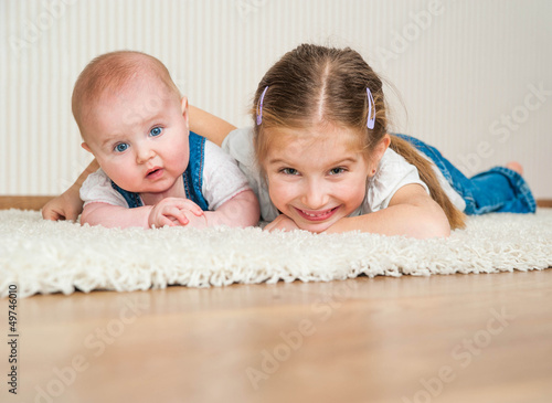 Photo: two sisters lying on the floor two sisters lying on the floor