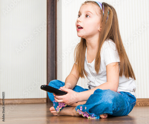Photo: girl holding a remote control girl holding a remote control