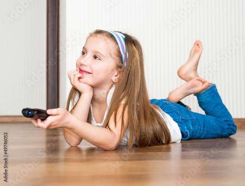 Photo: girl holding a remote control girl holding a remote control