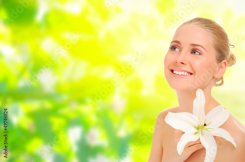 Photo: Young healthy woman on spring background Young healthy woman on spring background