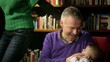 Video: Family portrait, adult couple playing with little baby at home Family portrait, adult couple playing with little baby at home