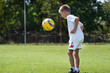 boy kicking football