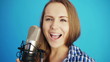 young woman singing a song at studio