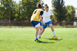 girls playing football outside