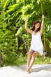 Photo: young beautiful woman swinging on natural background young beautiful woman swinging on natural background