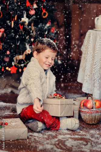 Photo: boy with a basket of toys in the background of a beautiful Chri boy with a basket of toys in the background of a beautiful Chri