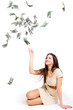 Young woman throwing money up isolated on white