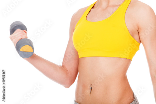 Photo: Female hand with a grey barbell, isolated on white Female hand with a grey barbell, isolated on white
